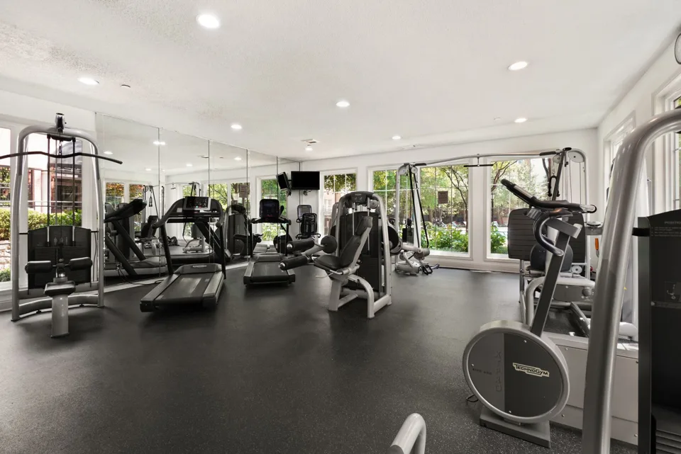 Gym interior with exercise equipment and open floor areas